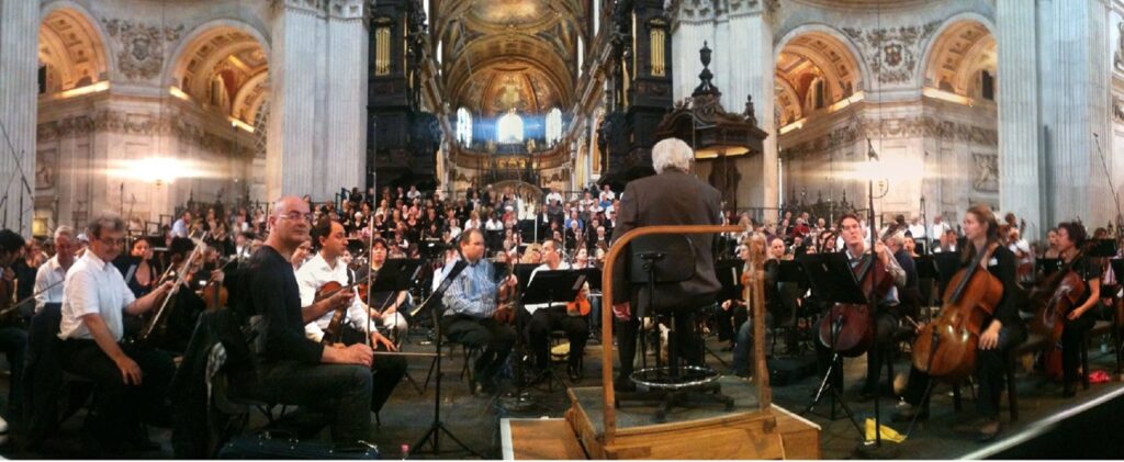 Orchestra members waiting for direction from their conductor