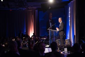 Starbucks Chairman, Howard Schultz speaks at a podium after receiving an award